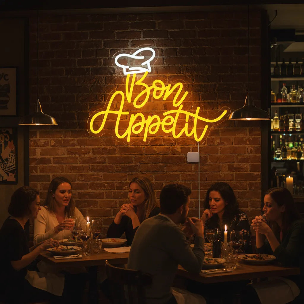 Neon 'Bon Appetit' sign above a group of people dining in a restaurant.
